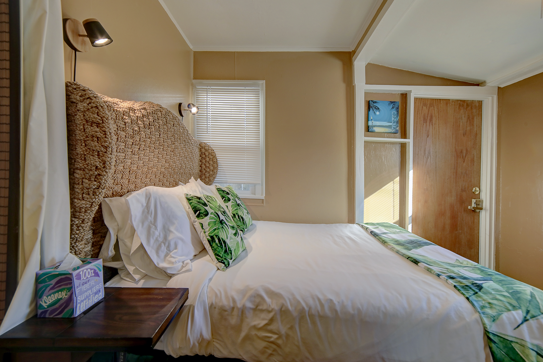 a bedroom with a bed , nightstand , and window .