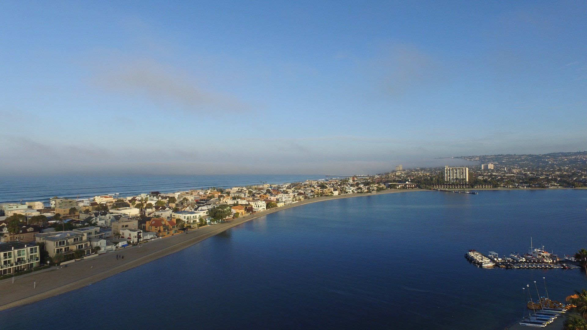 an aerial view of a city next to a body of water .