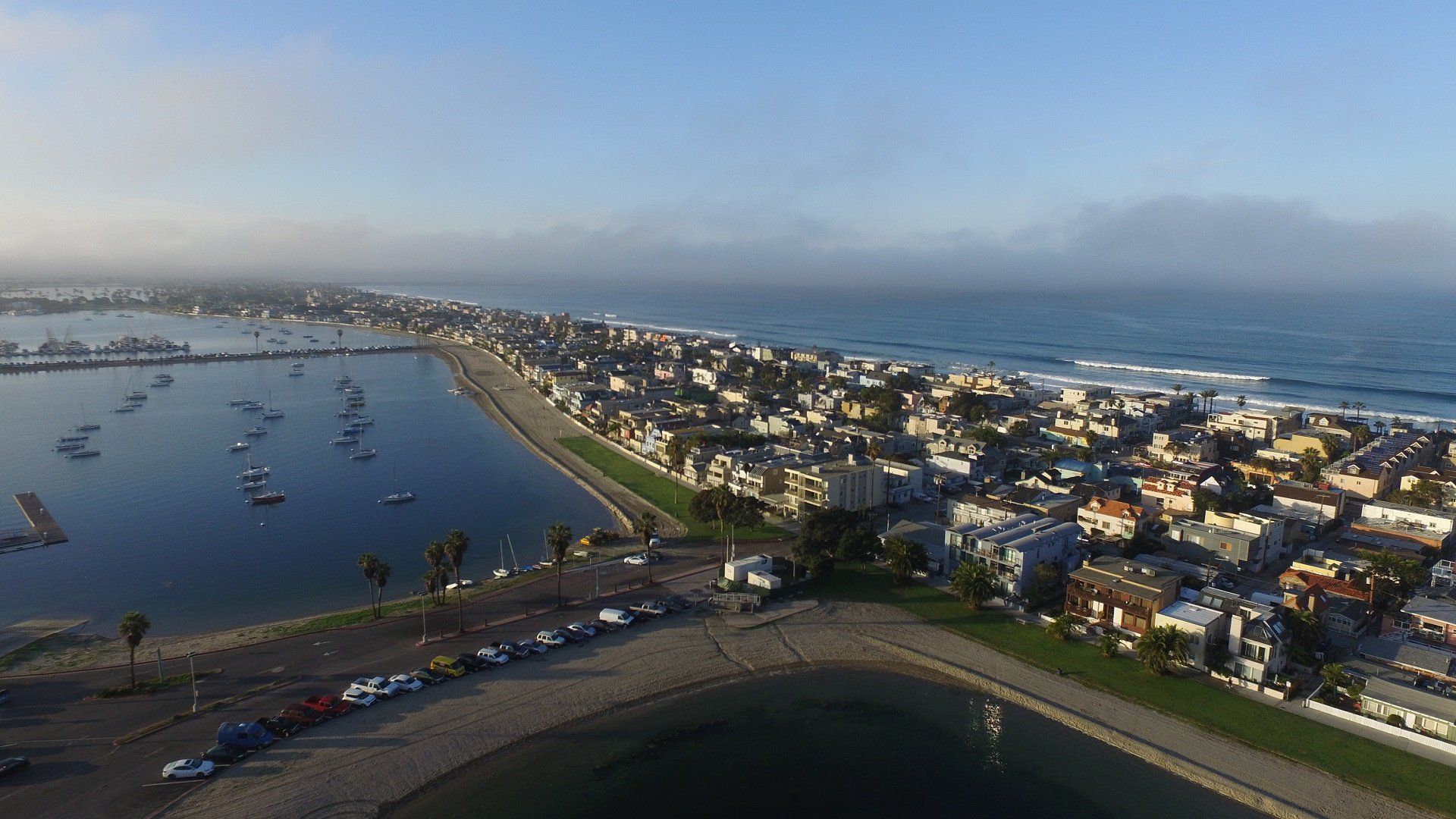 an aerial view of a city next to a body of water .