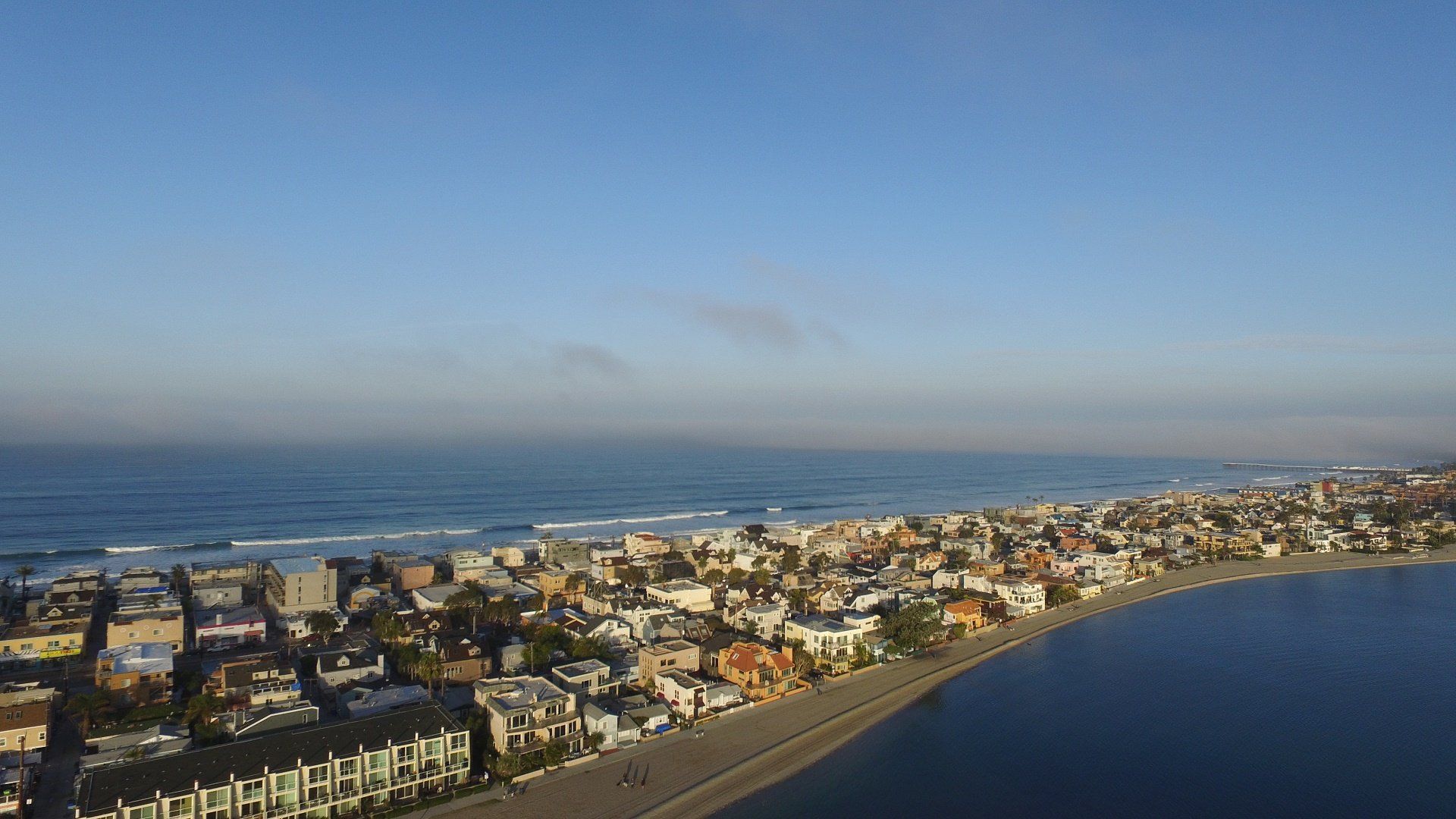 an aerial view of a city next to a body of water .