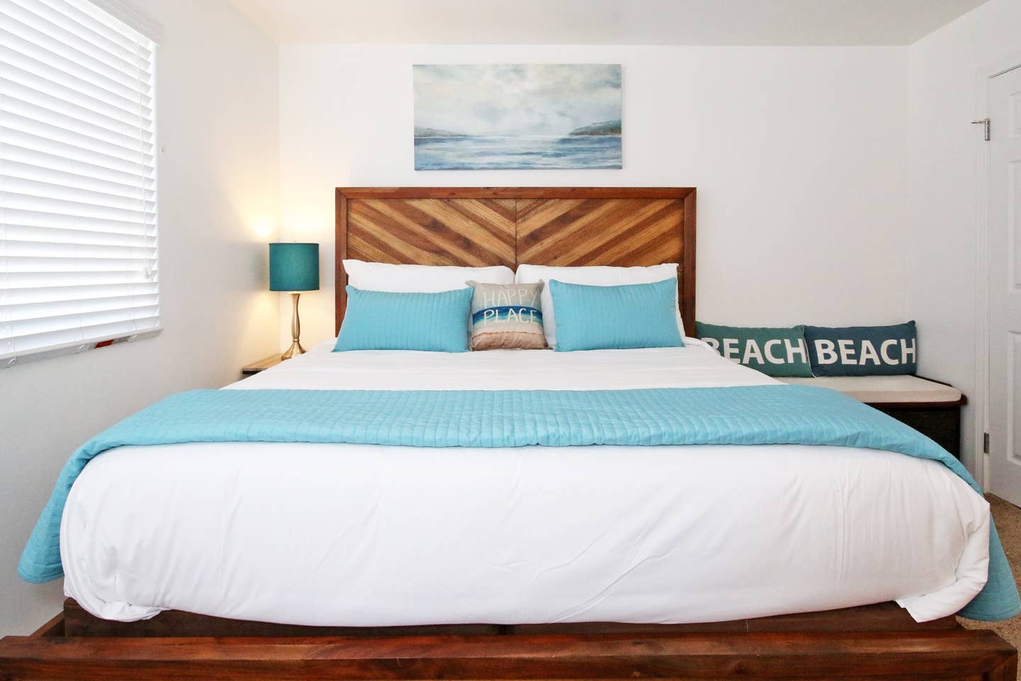 A bedroom with a king size bed and a sign that says beach beach.