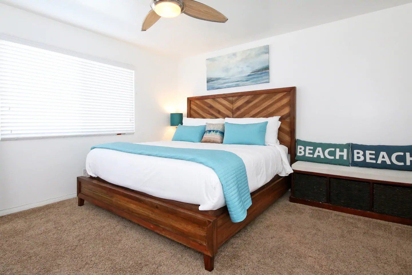 A bedroom with a king size bed and a sign that says beach beach.