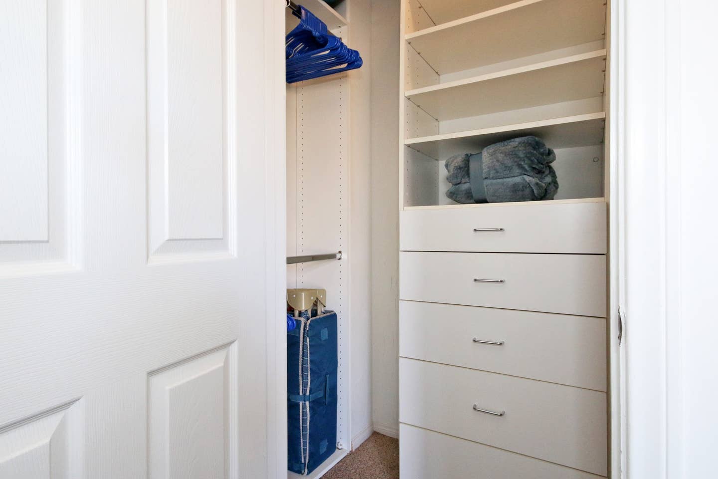 A walk in closet with lots of shelves and drawers.