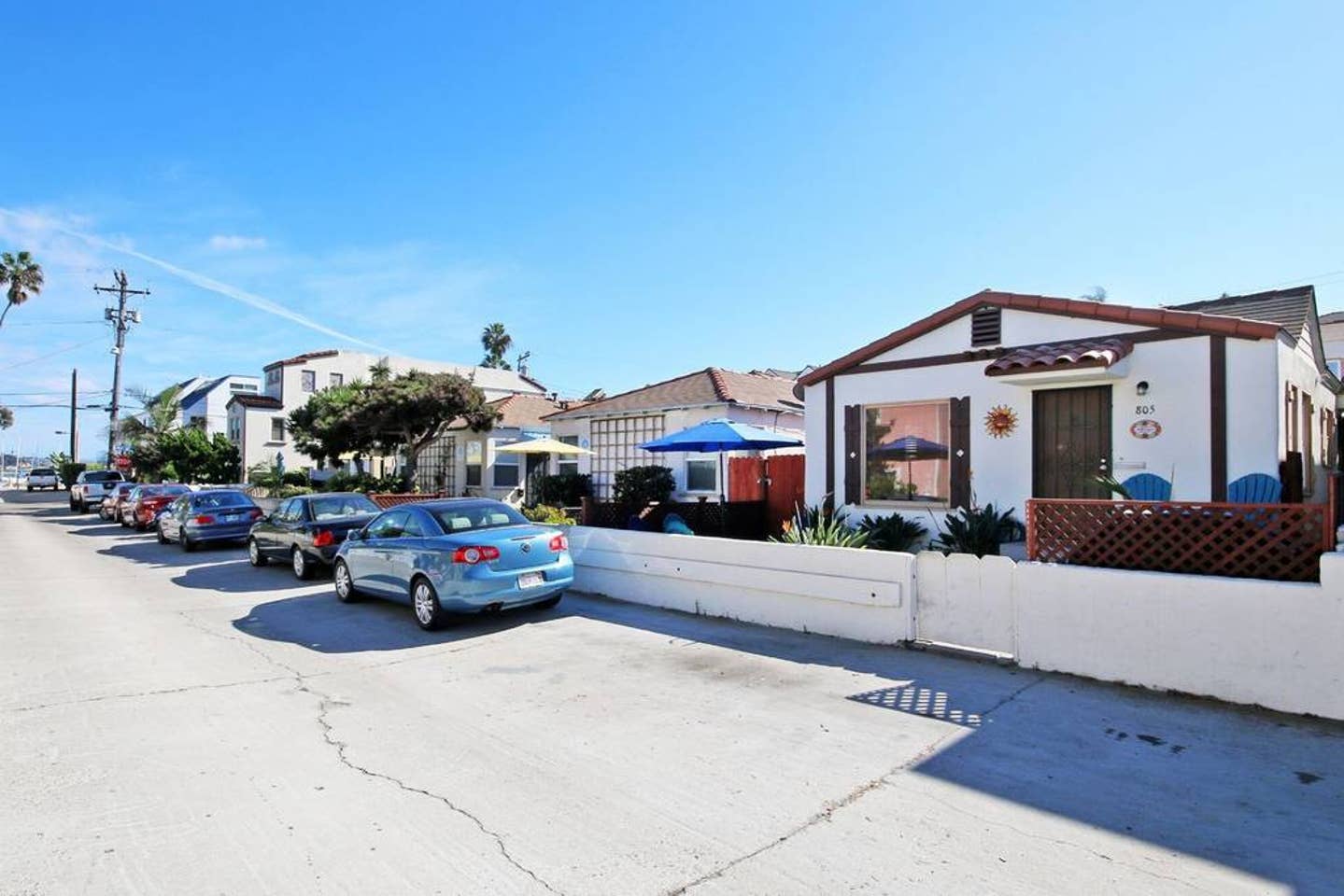 a row of cars are parked in front of a house