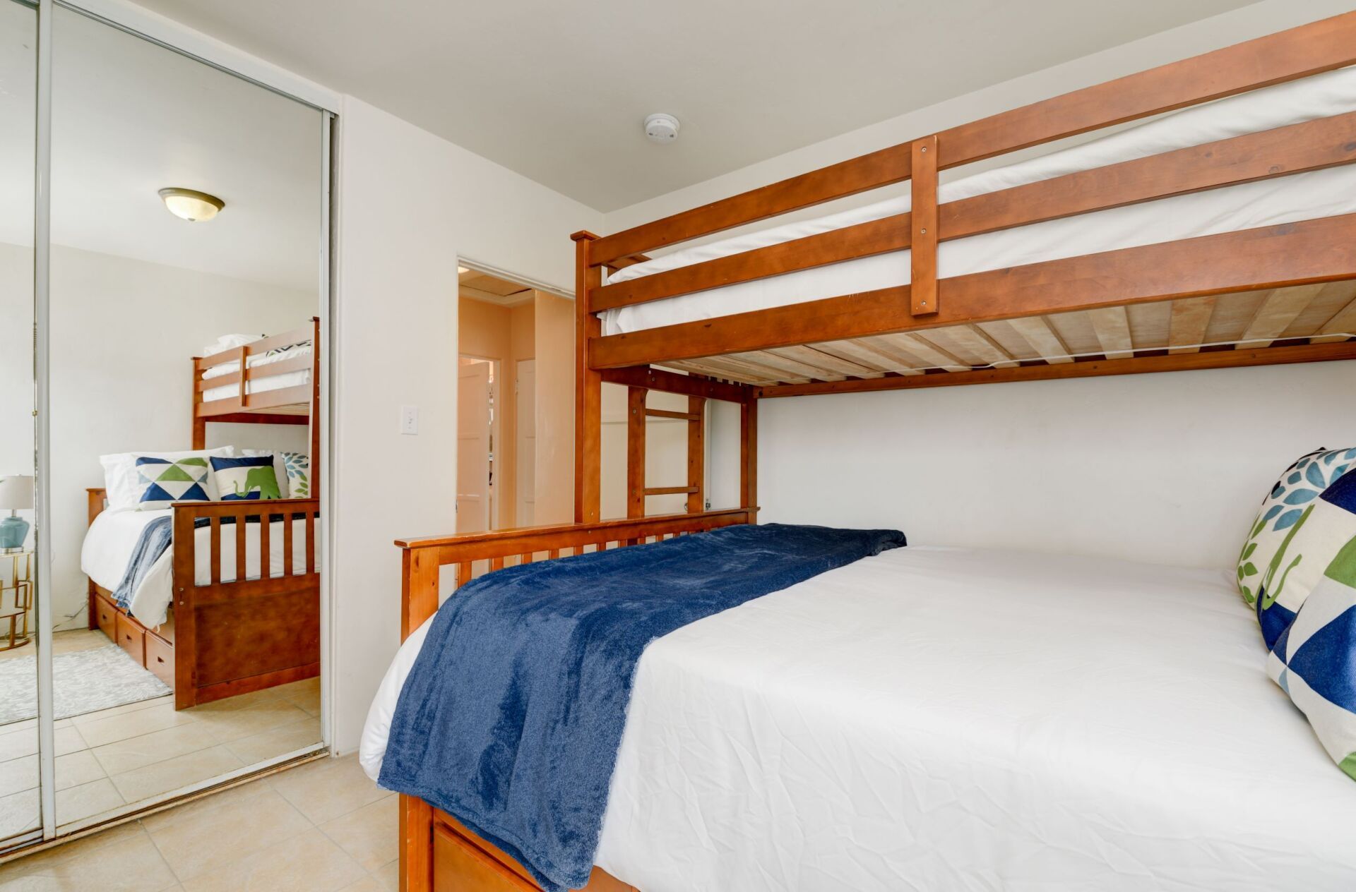 A bedroom with a bunk bed and a king size bed