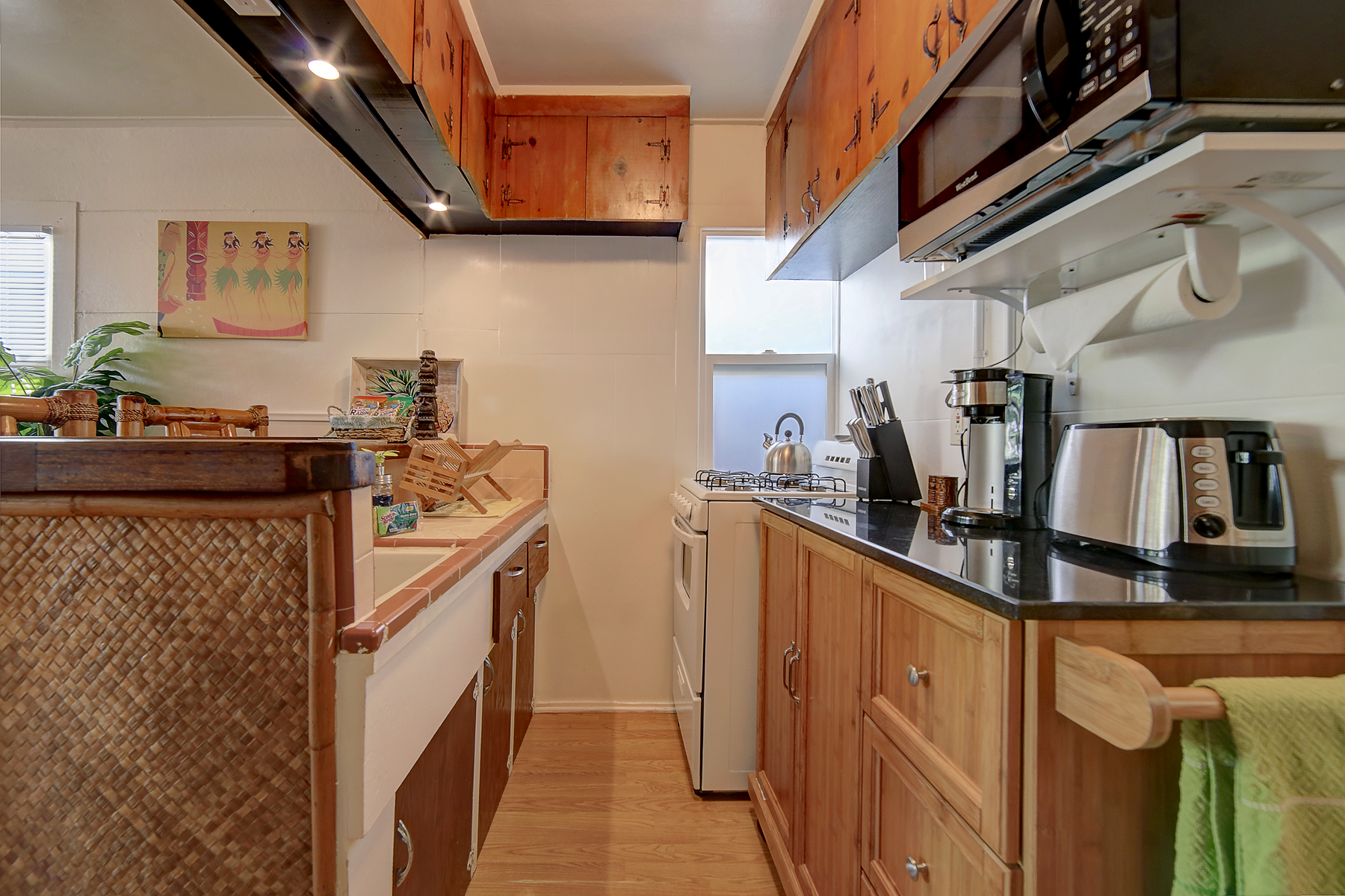 a kitchen with wooden cabinets and a microwave
