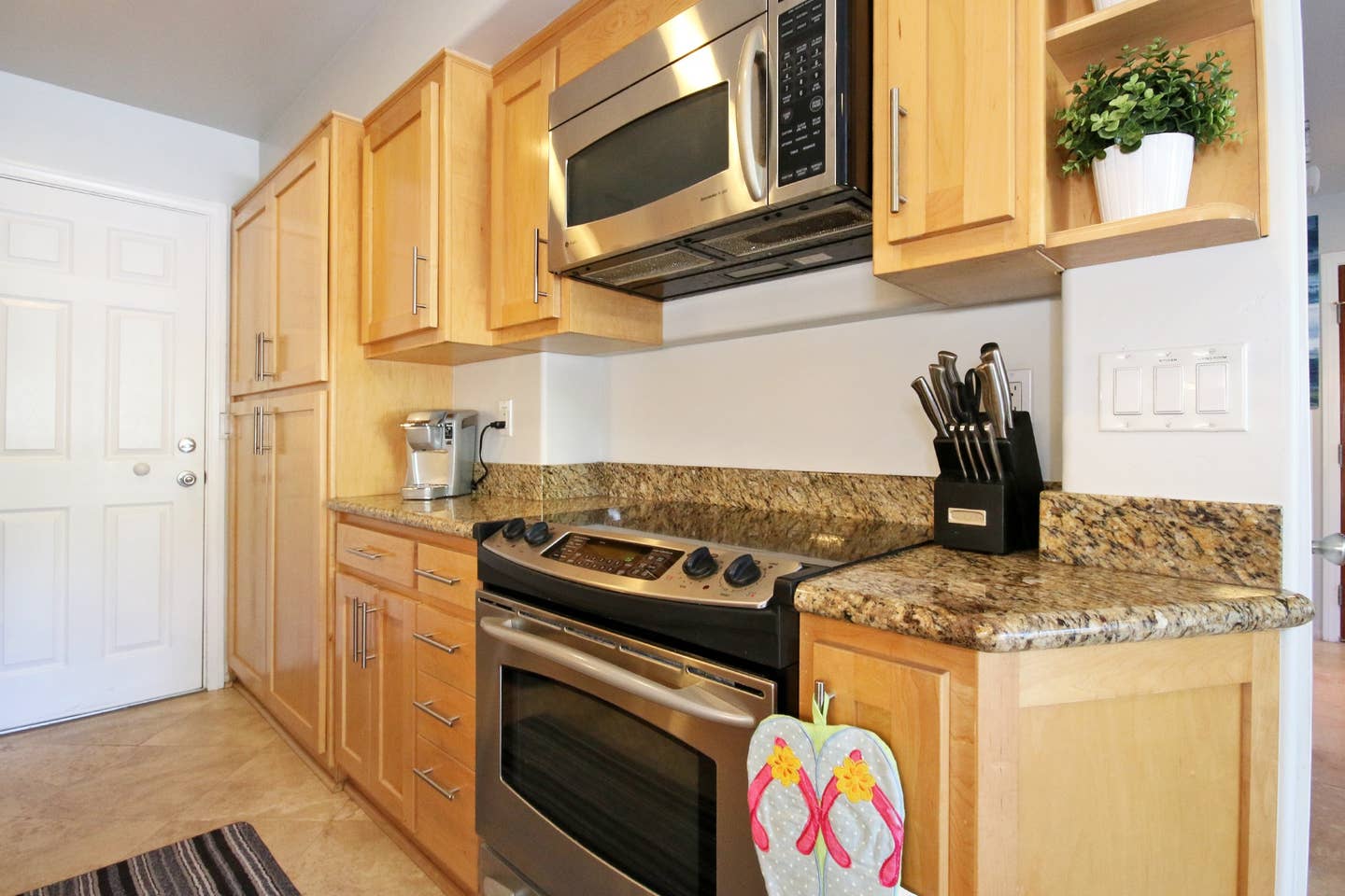 a kitchen with stainless steel appliances and wooden cabinets