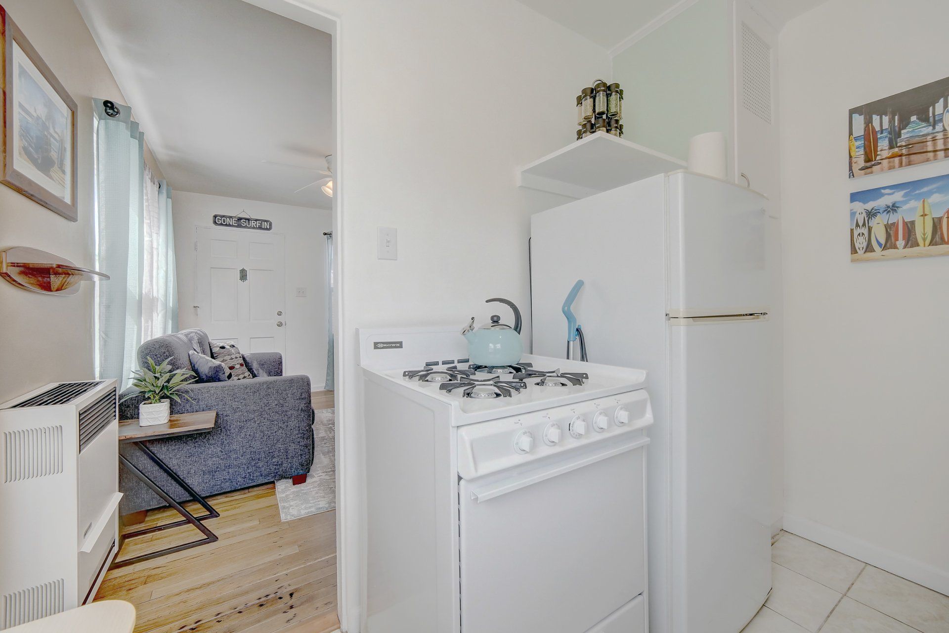 A kitchen with a stove , refrigerator , and microwave.