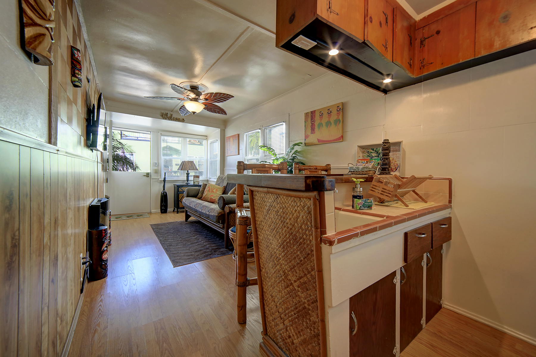 a living room with a couch and a ceiling fan