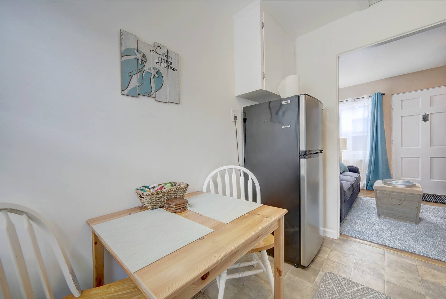 a kitchen with a table and chairs and a refrigerator .