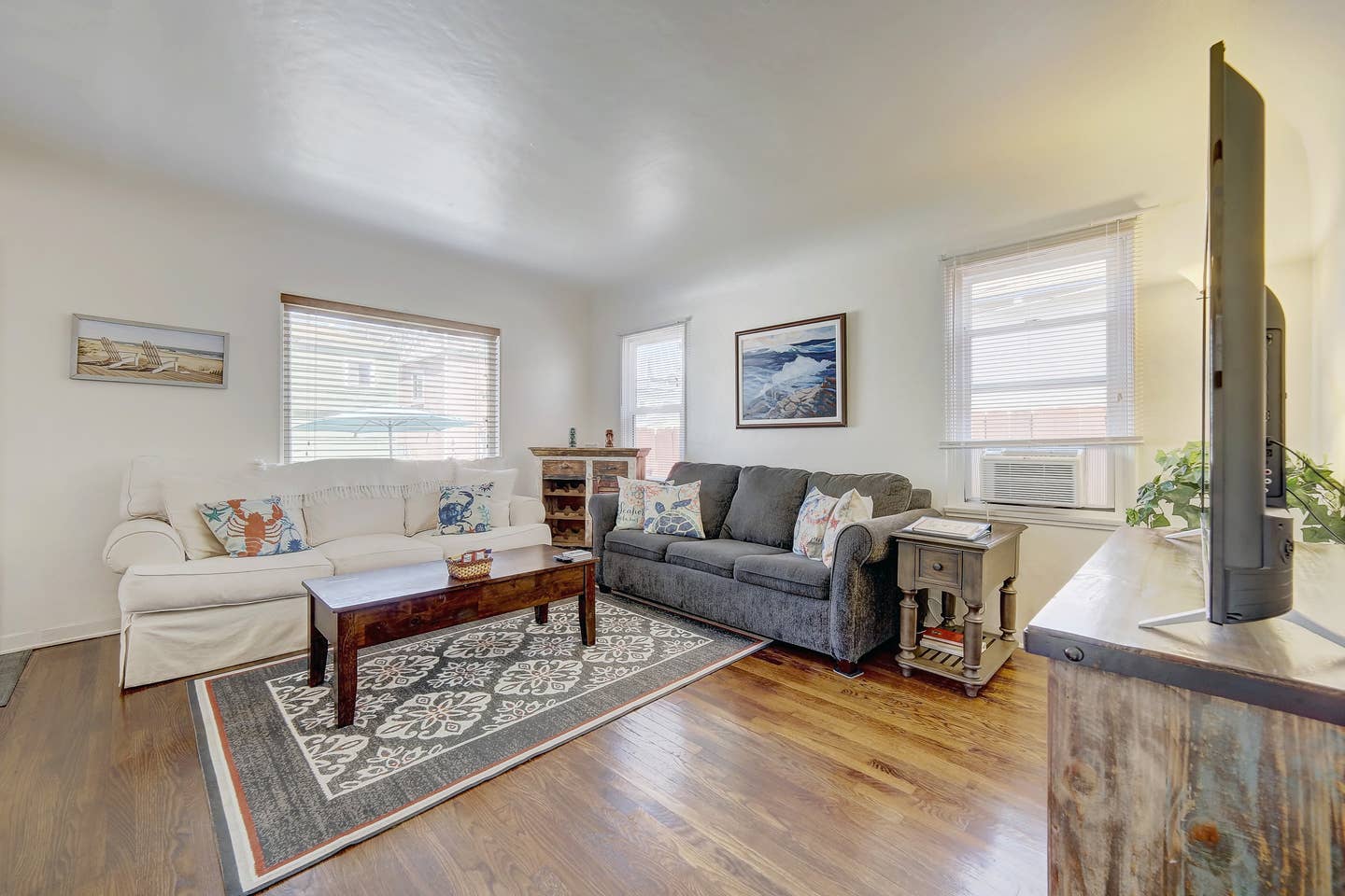 A living room with a couch , coffee table , and television.