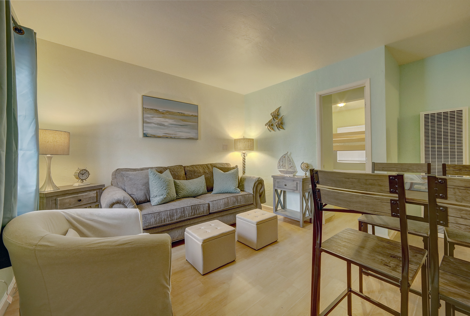 A living room with a couch , chair , table and chairs.