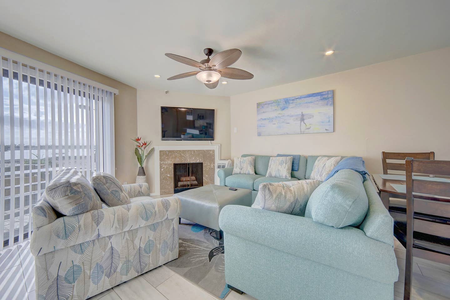 A living room filled with furniture and a ceiling fan.