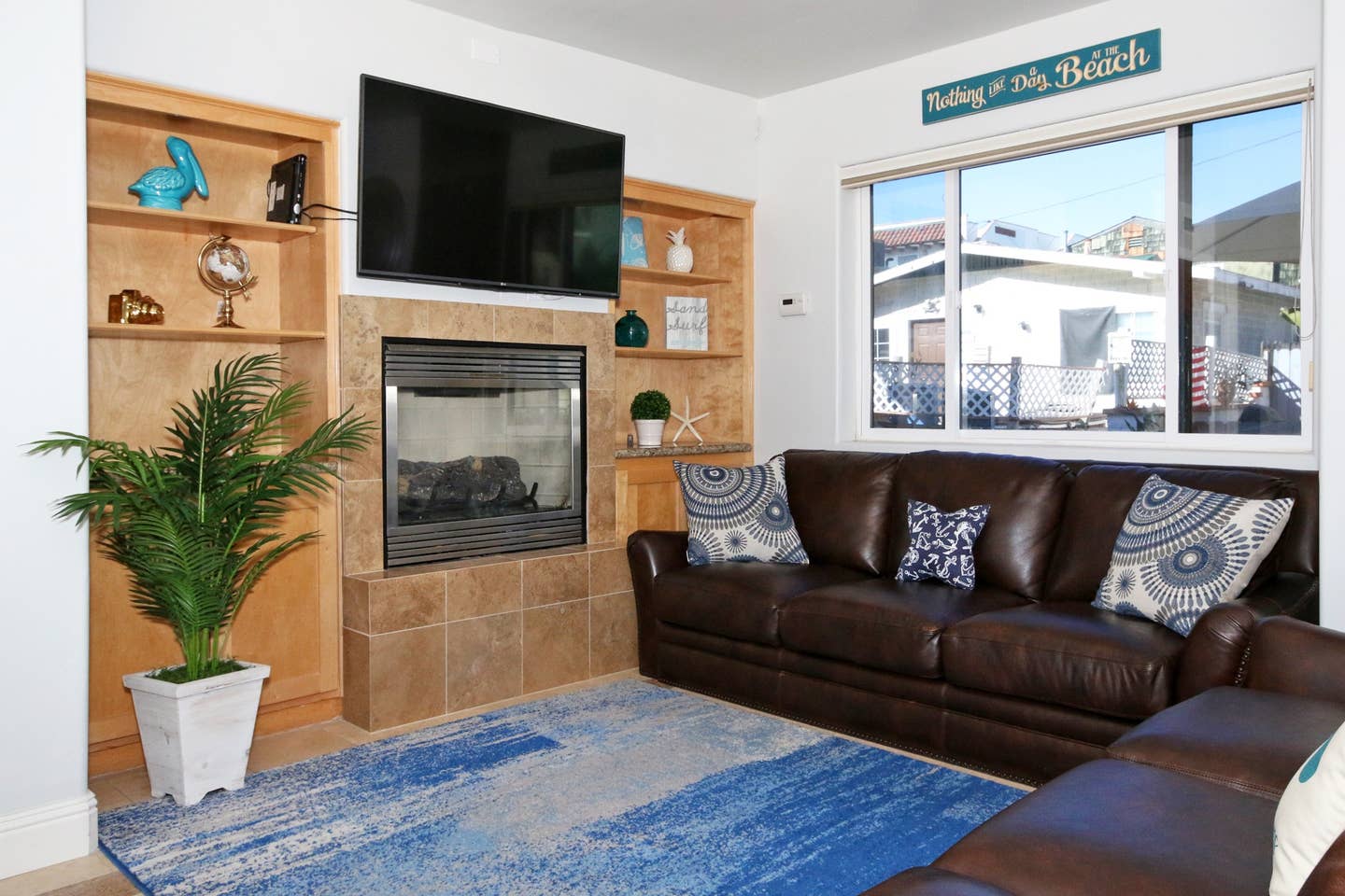 A living room with a couch , fireplace and television.