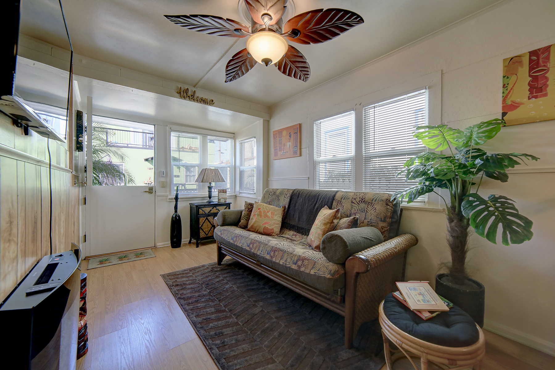 A living room with a couch and a ceiling fan