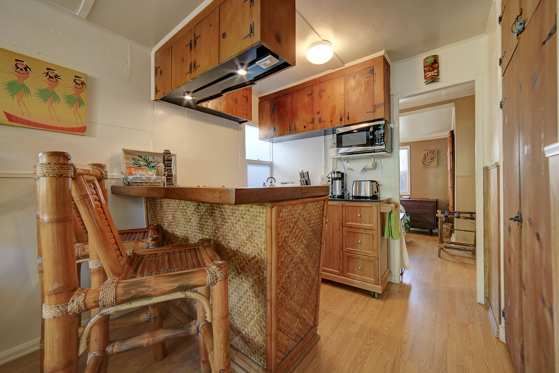 a kitchen with wooden cabinets and a bamboo bar .