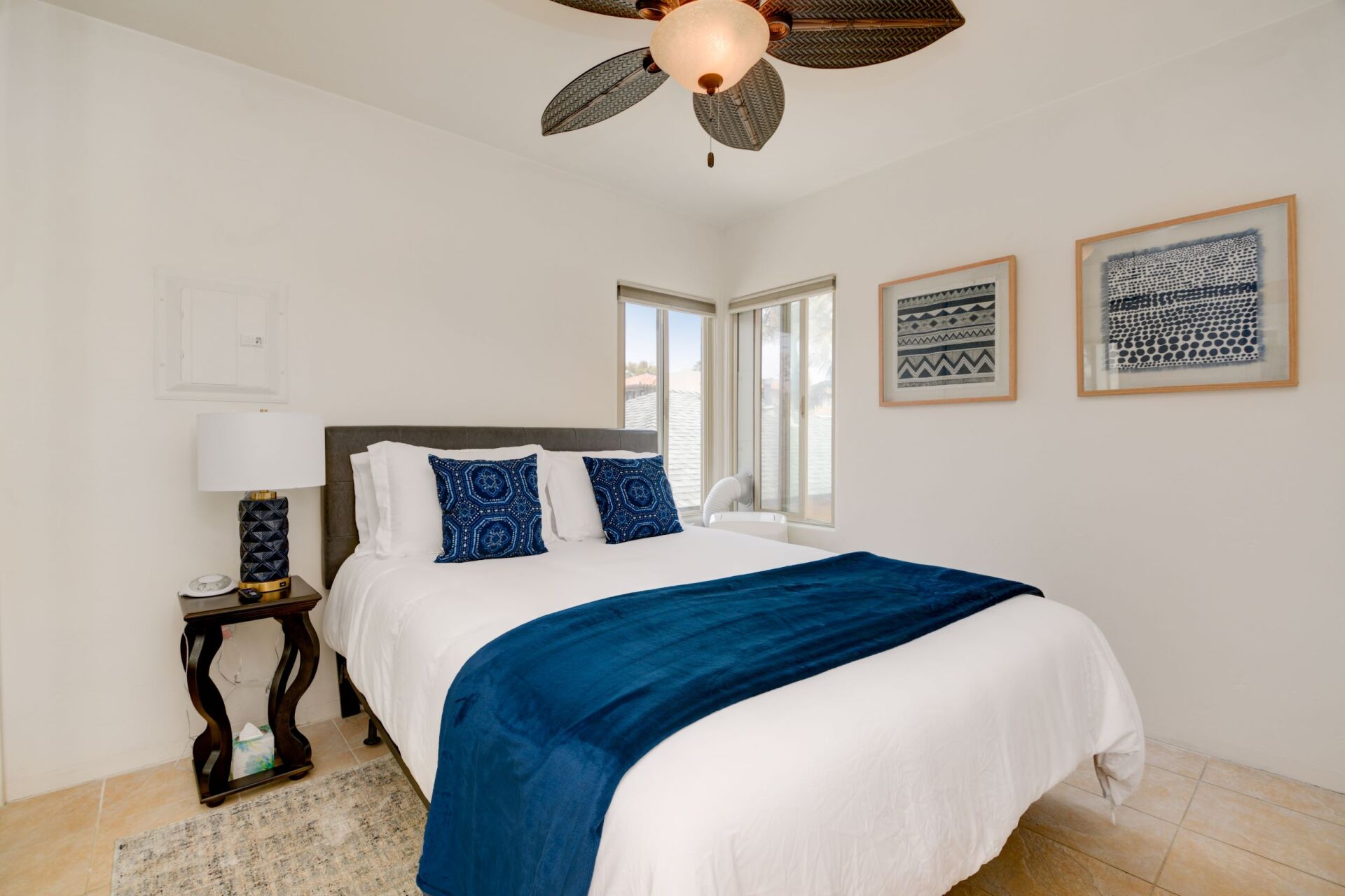 a bedroom with a bed and a ceiling fan