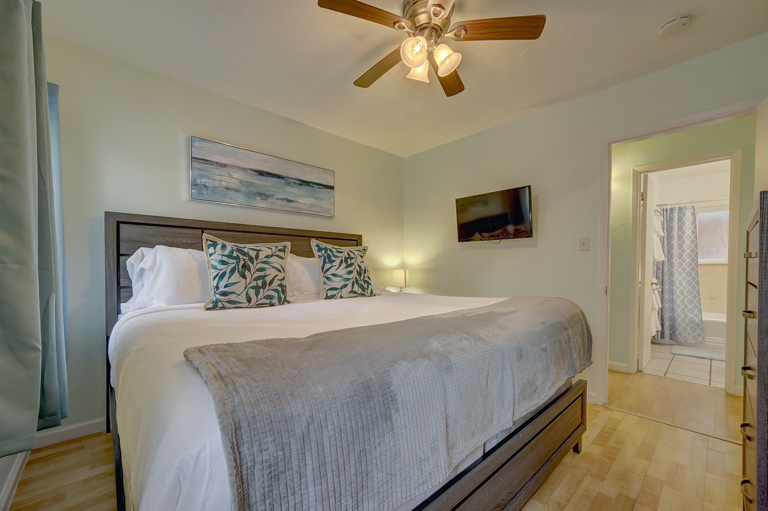 a bedroom with a king size bed and a ceiling fan .