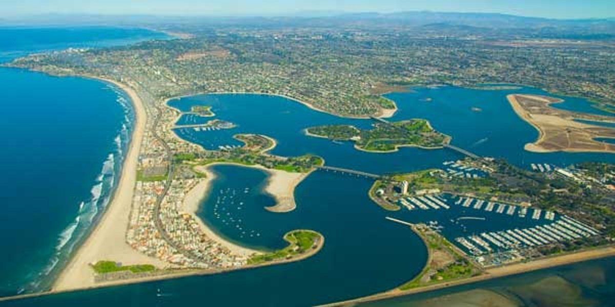 an aerial view of a large body of water with a city in the background .