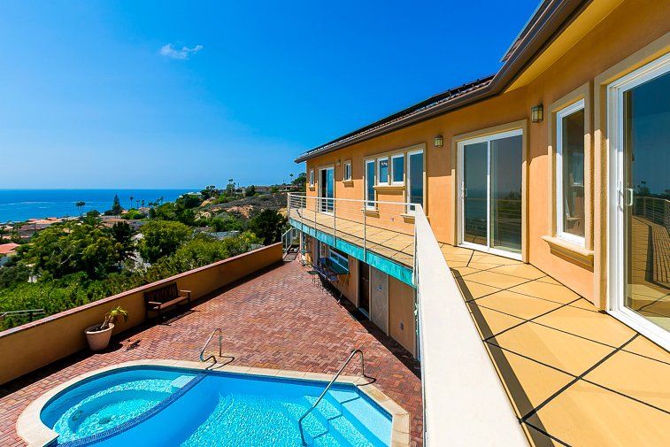 a large house with a swimming pool in front of it