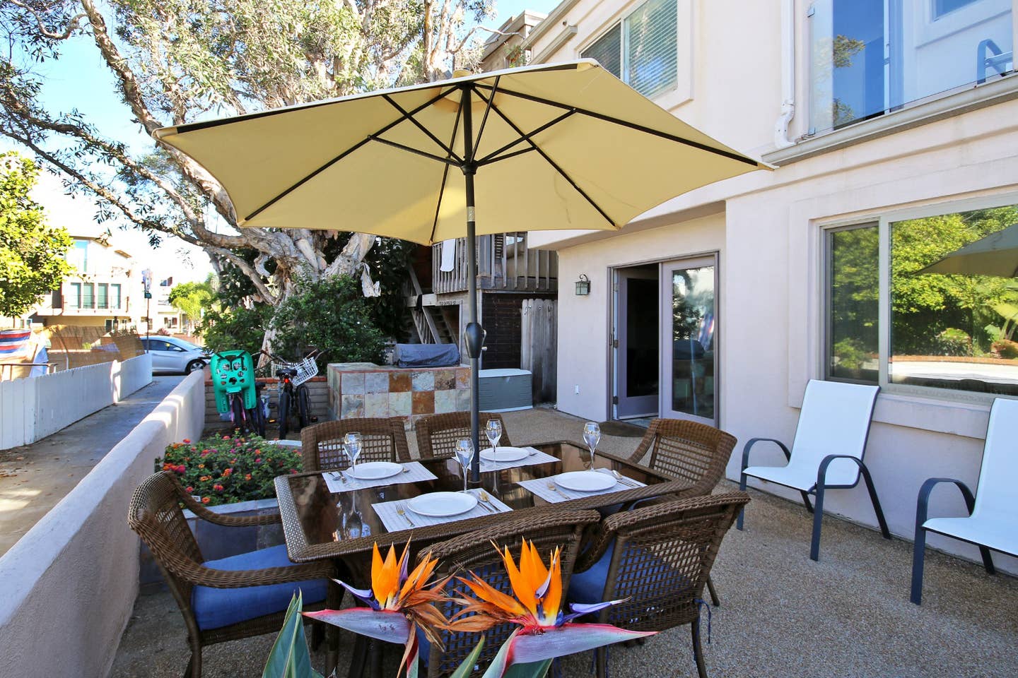 a patio with a table and chairs under an umbrella