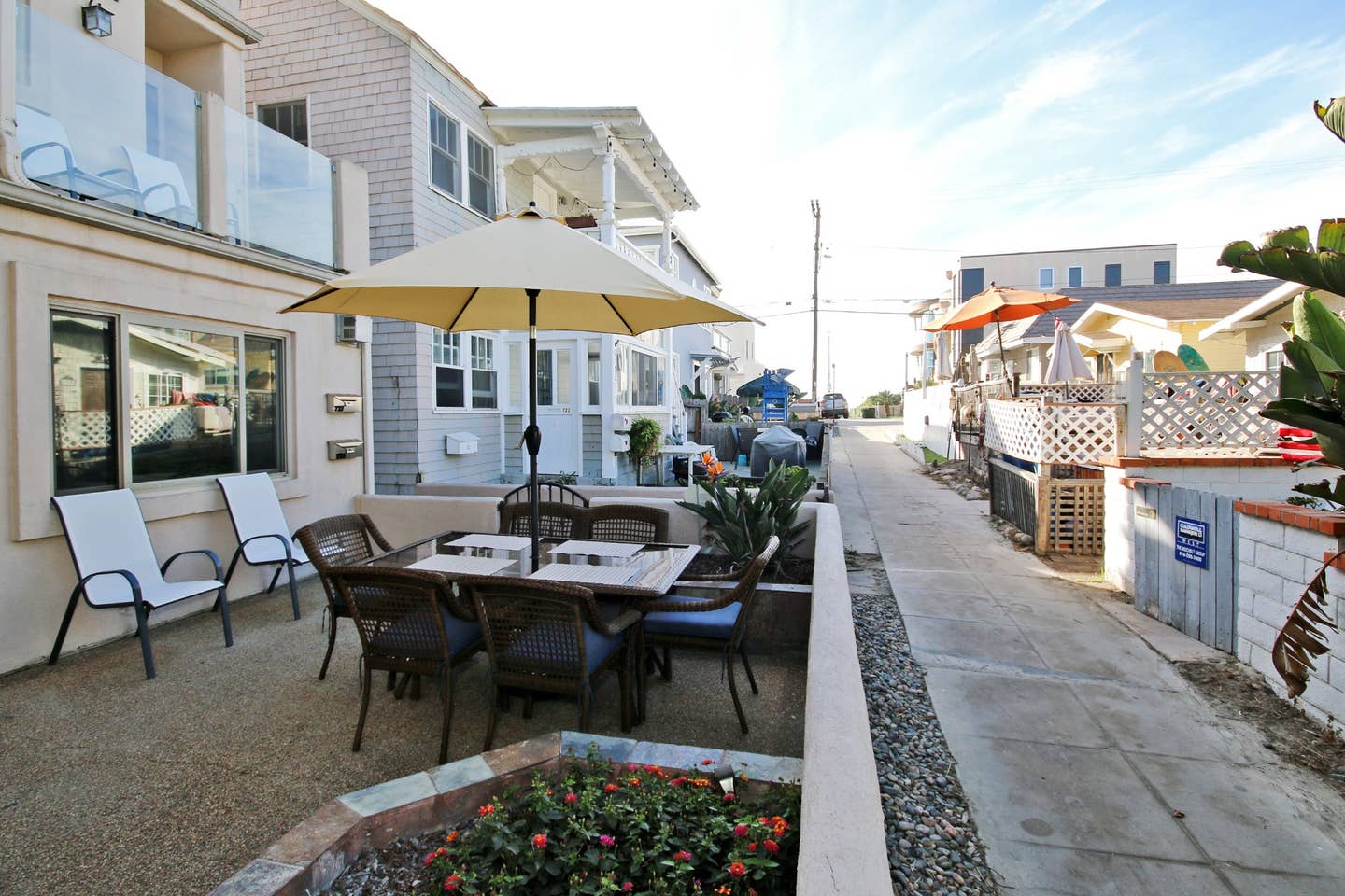 a patio with a table and chairs under an umbrella