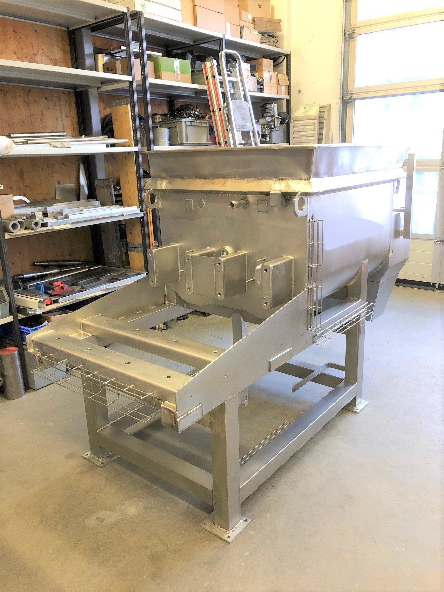 In einem Raum steht eine große Maschine aus Edelstahl.