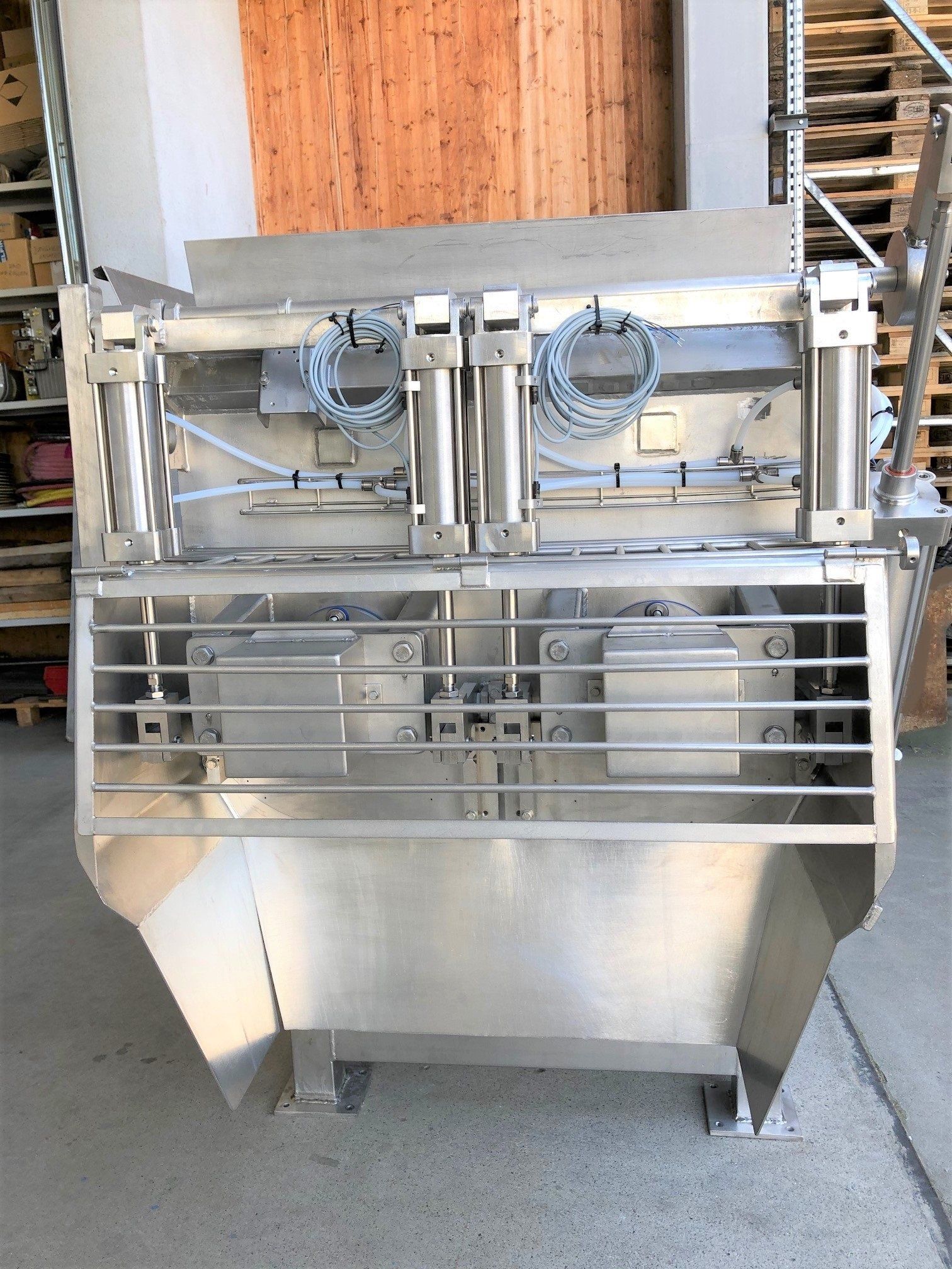 Eine große Maschine aus Edelstahl steht in einem Lager