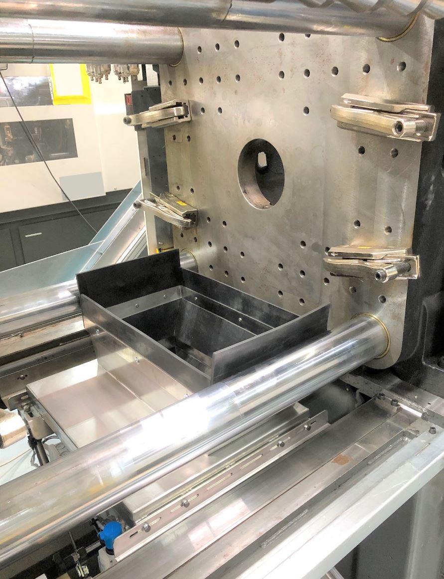 Eine Maschine mit einem Tablett darauf in einer Fabrik.