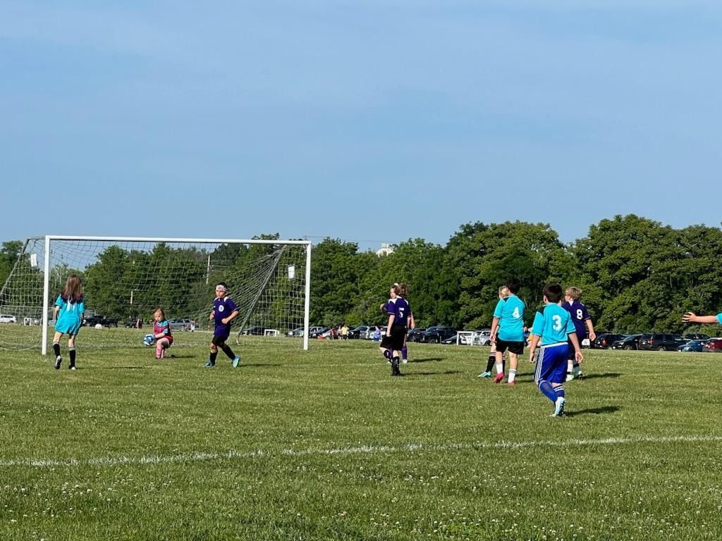 Clarke County Soccer League  players going to goal.