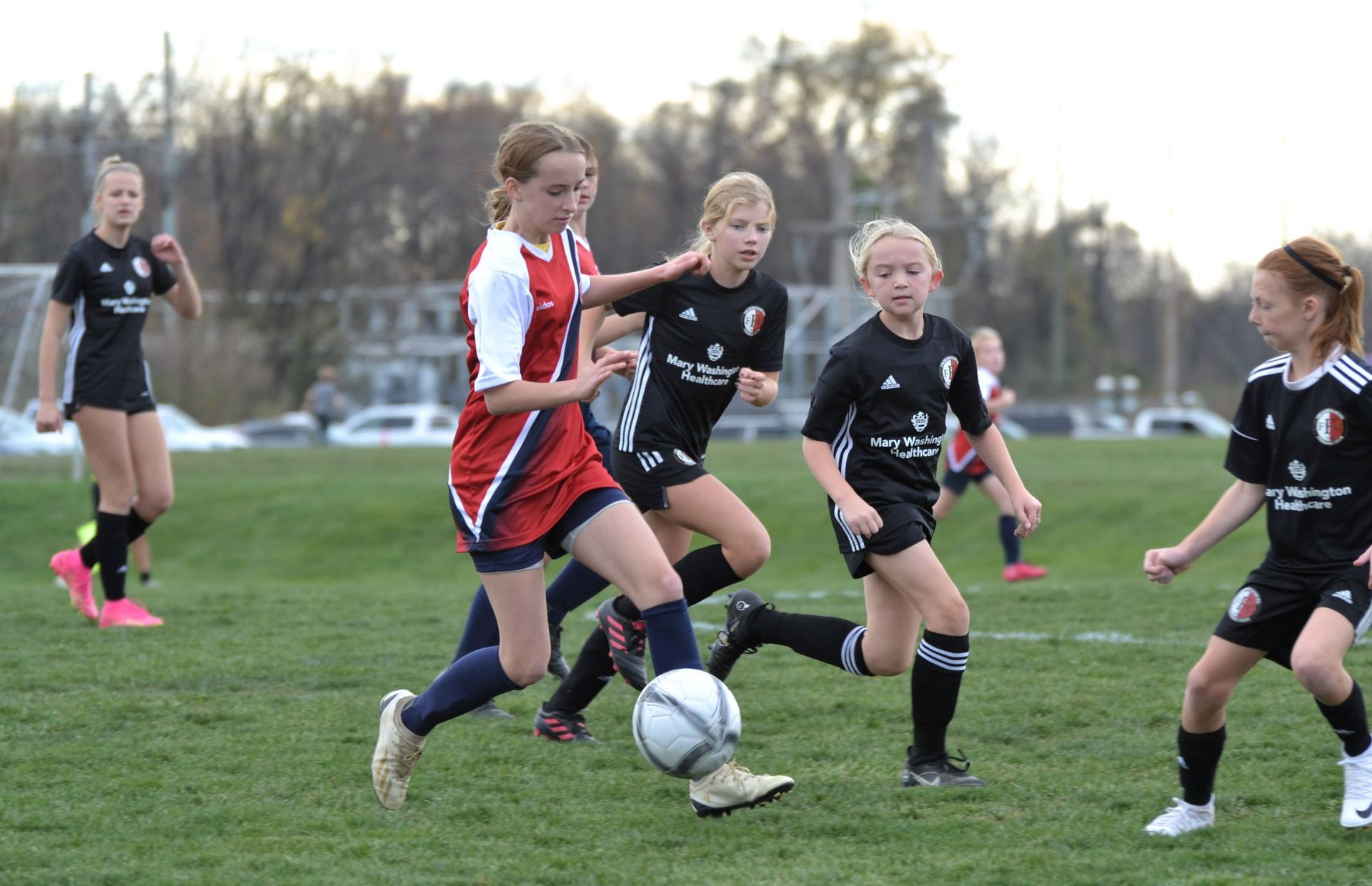 Clarke County Soccer League's female travel player dribbling against 4 players. 
