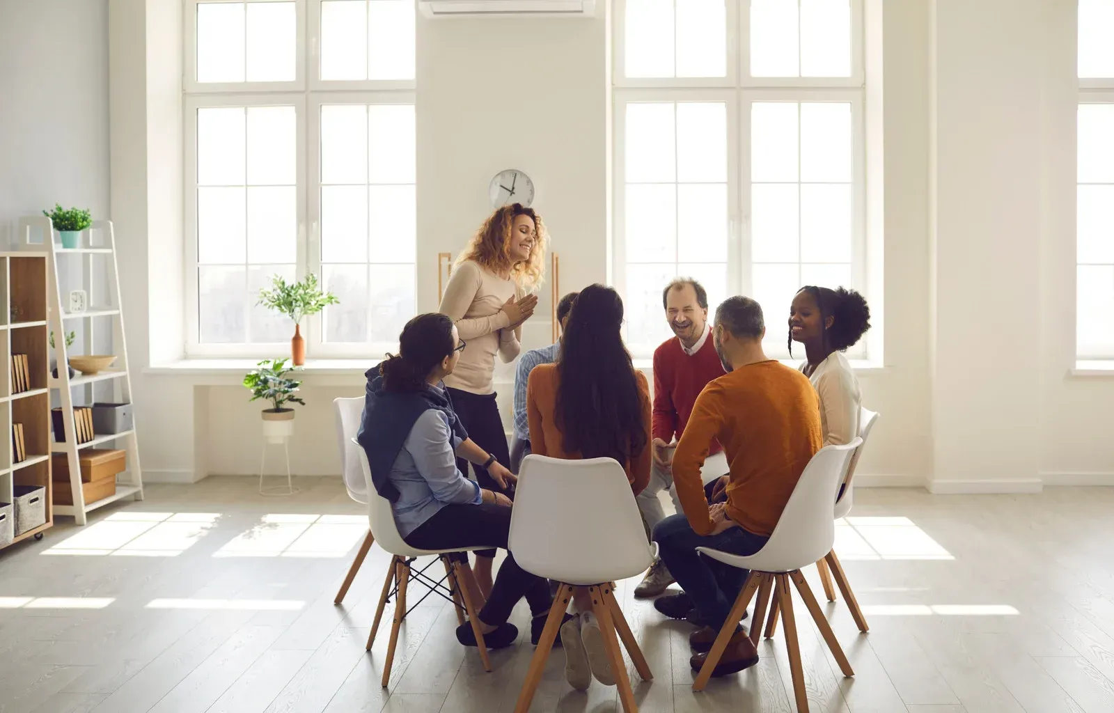 A group of people are sitting in a circle in a room.