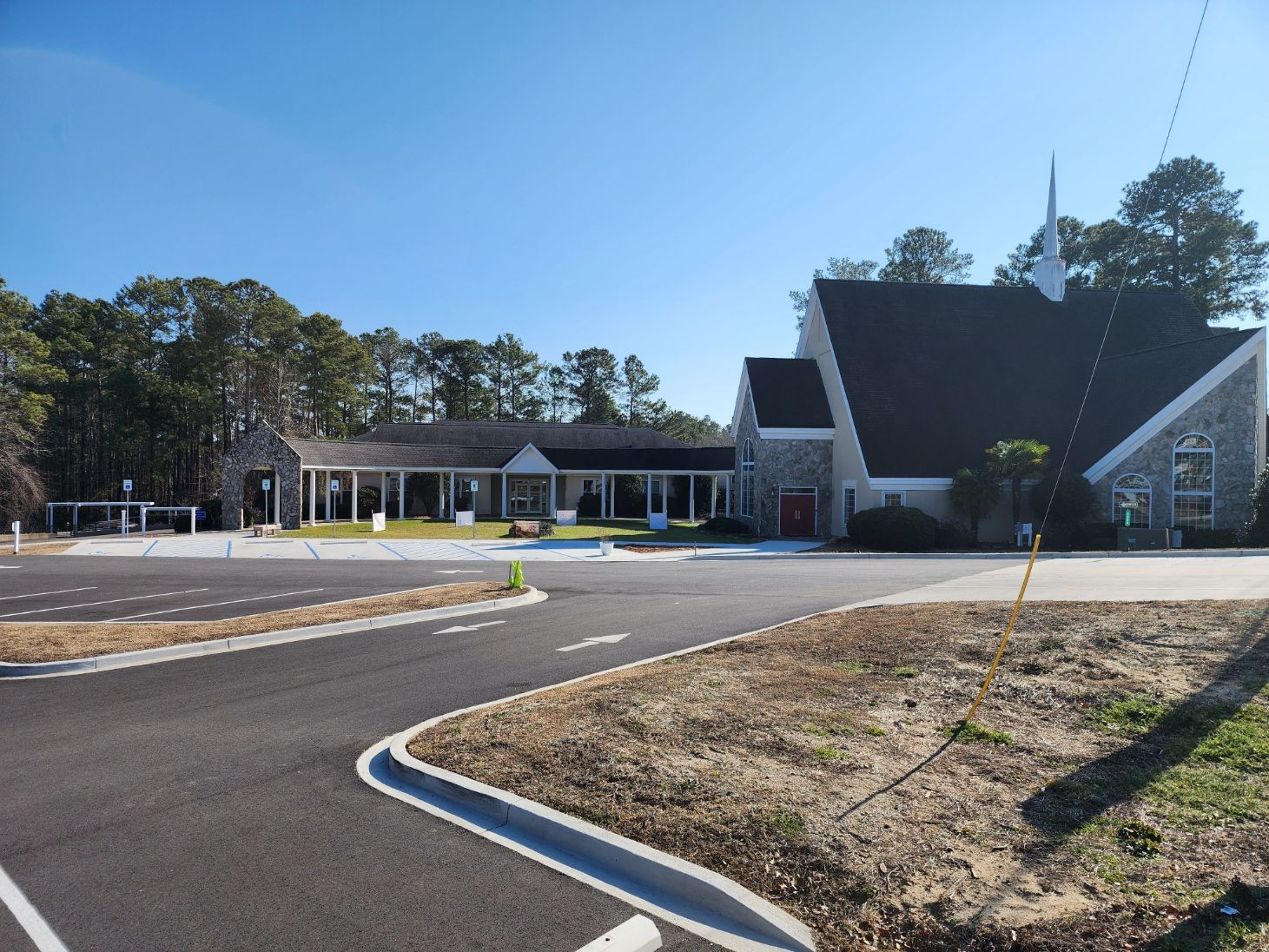 Conference room with a whiteboard, table, and chairs. Plants and objects decorate the table.