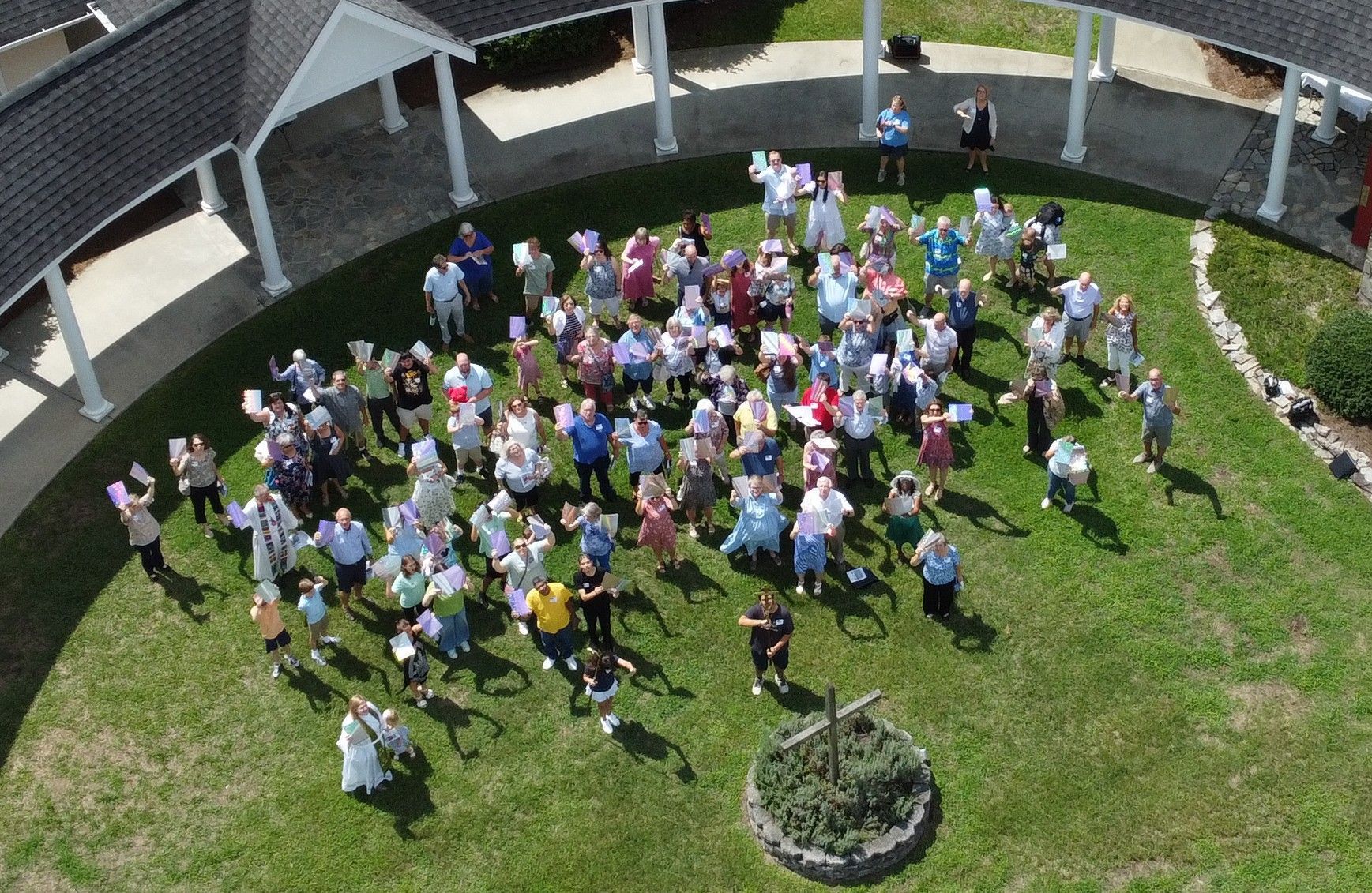 Conference room with a whiteboard, table, and chairs. Plants and objects decorate the table.