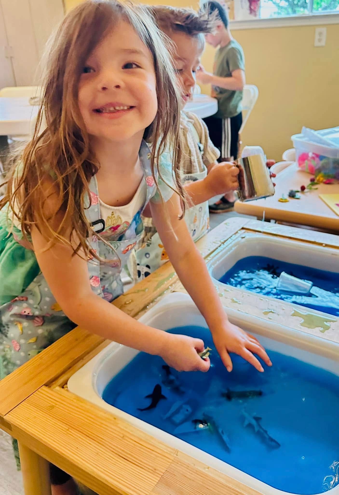 A young boy wearing glasses is laying on the floor reading a book.