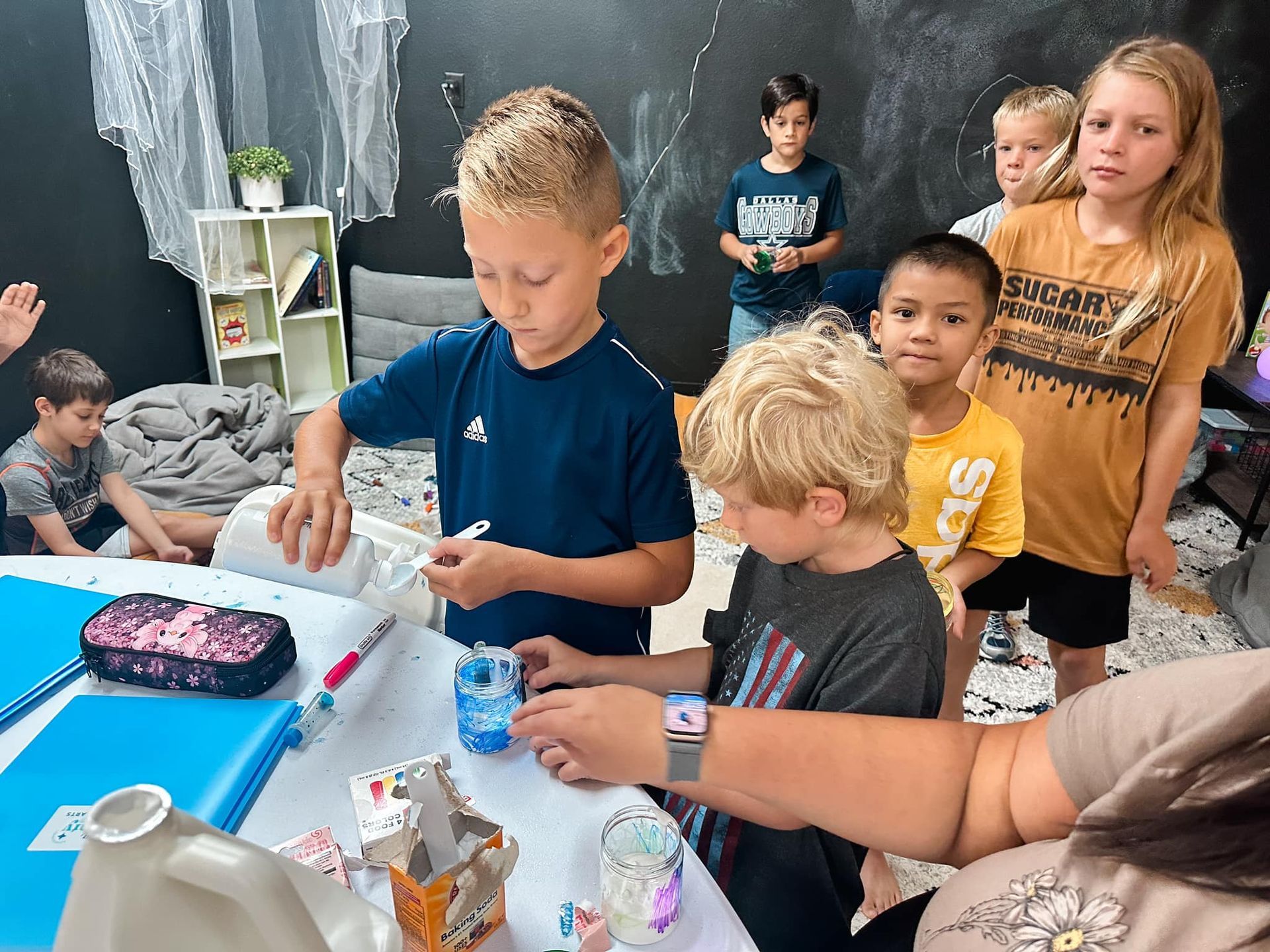 A little girl is looking through a magnifying glass in a science lab.