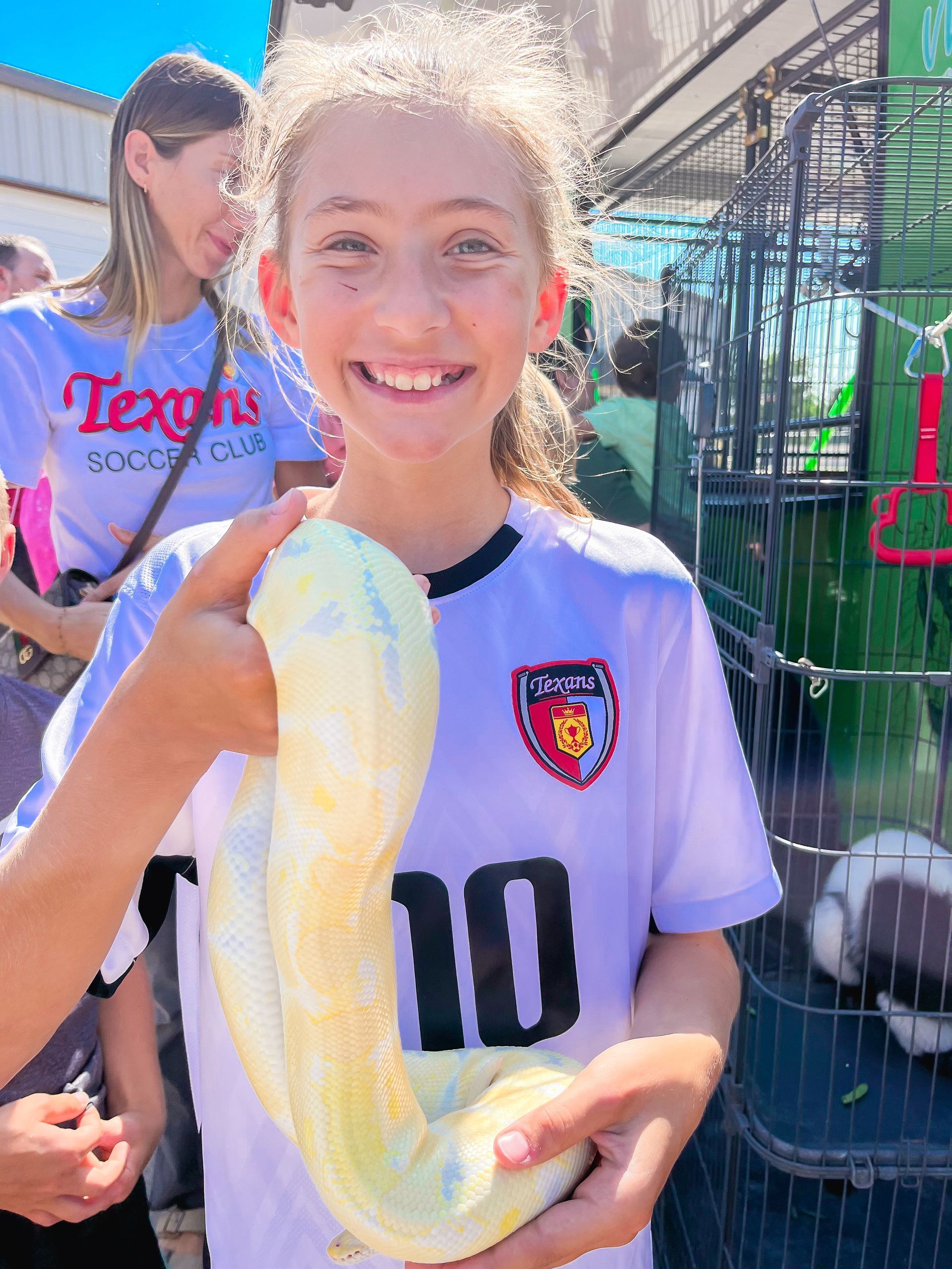 A young girl is holding a piece of paper with a picture of a wave on it.