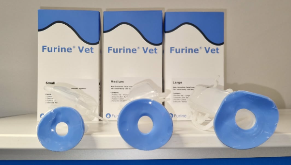 Three Furine Vet boxes behind three blue circular devices on a white shelf.