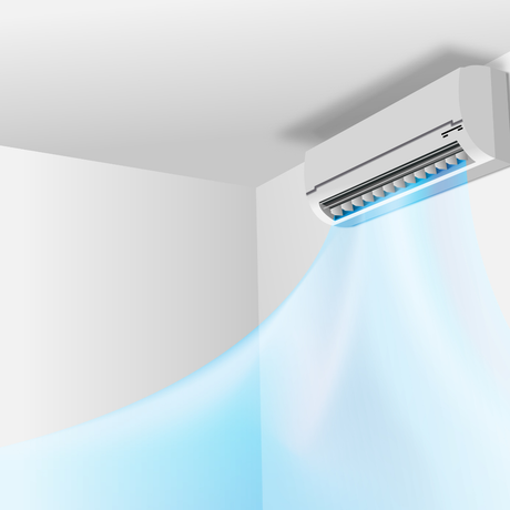 A white air conditioner is hanging from the ceiling in a room.