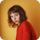 A woman in a red sweater is standing in front of a yellow wall.