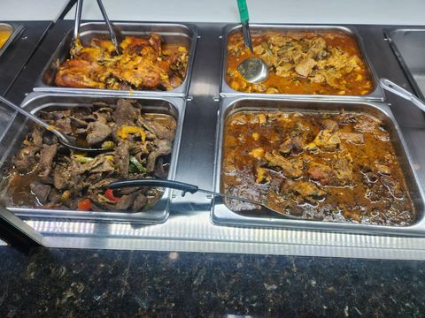 A buffet line filled with lots of different types of food.