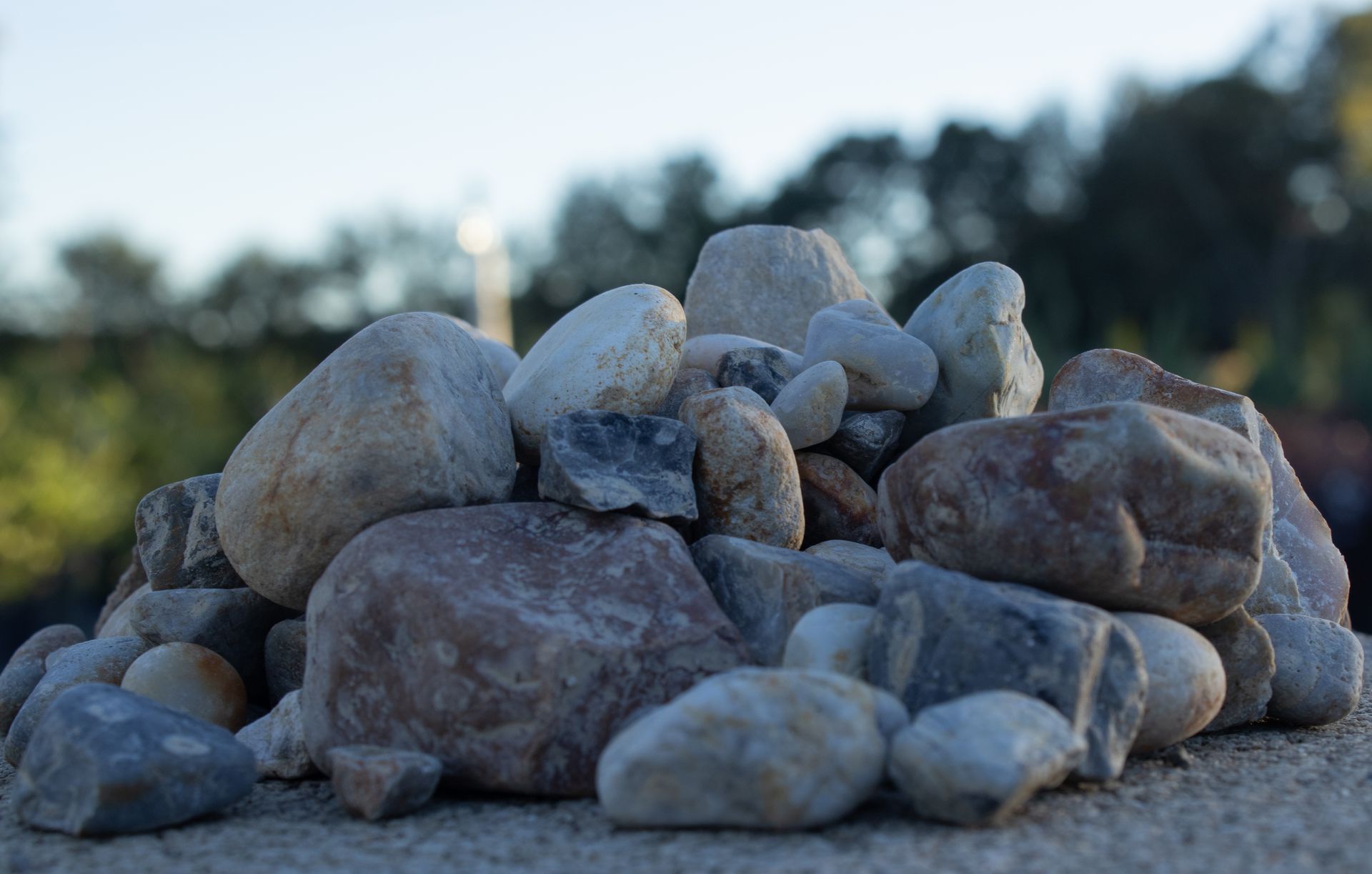 A pile of rocks sitting on top of a concrete surface.