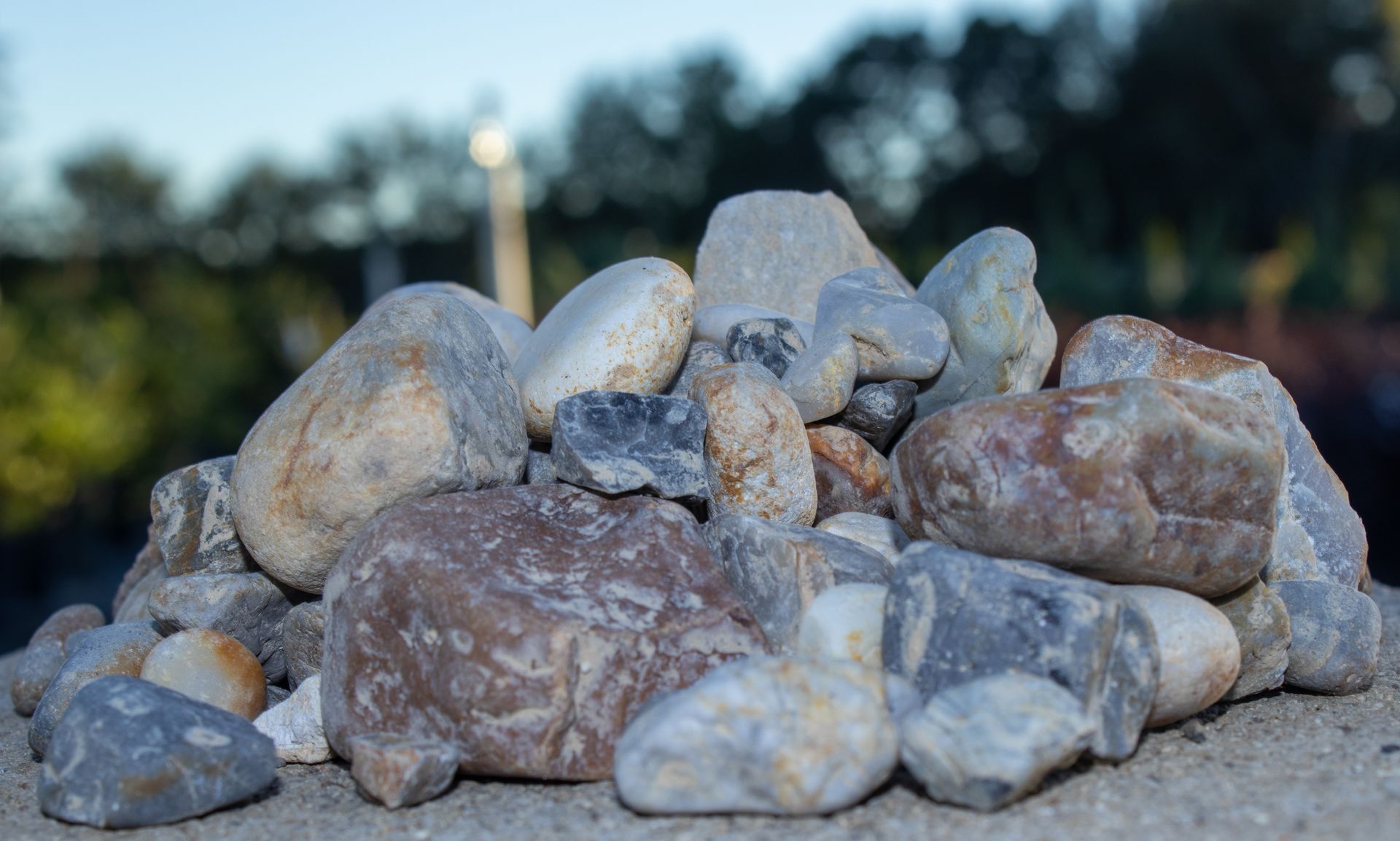 A pile of rocks sitting on top of a concrete surface.