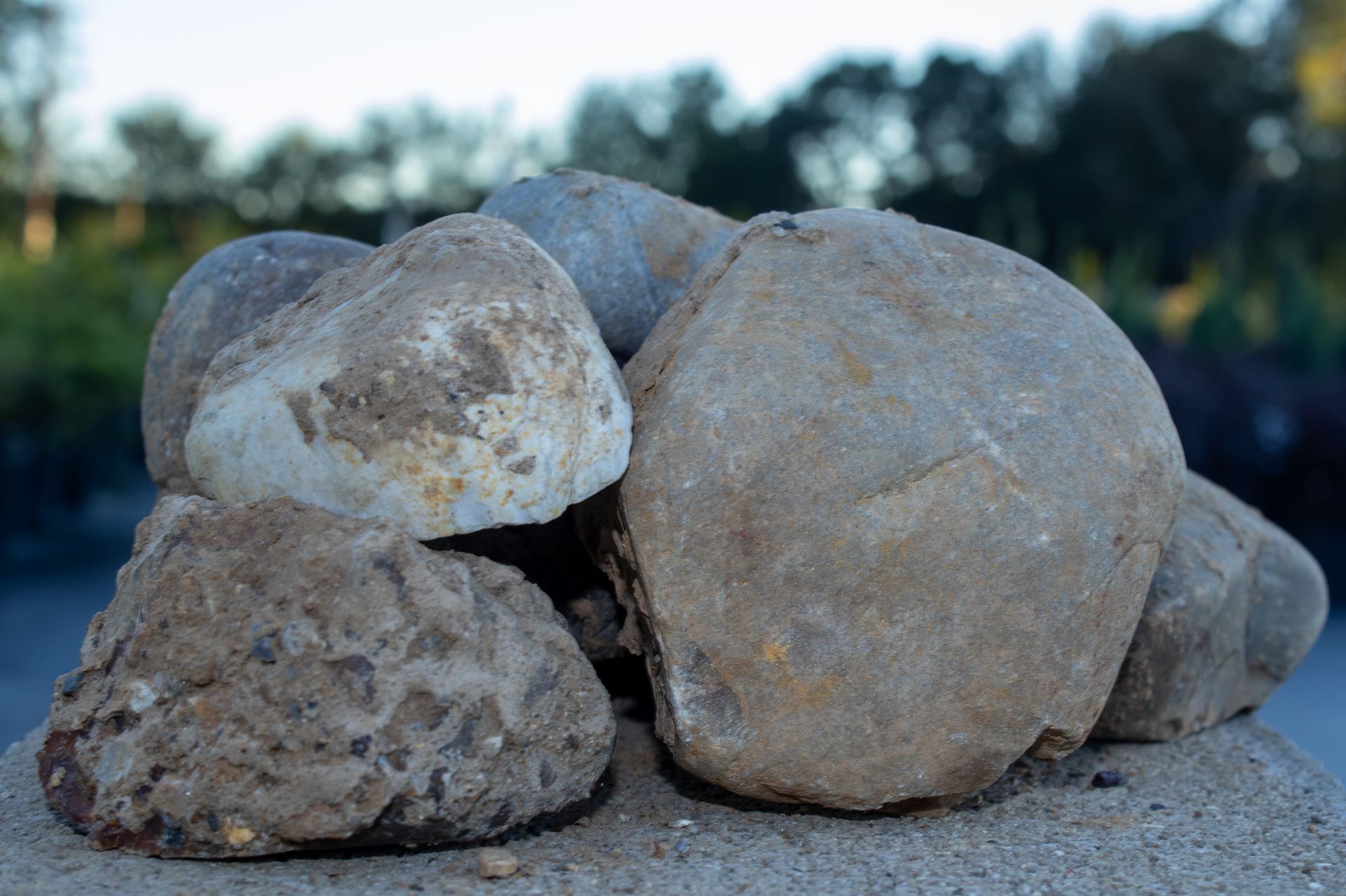 A pile of rocks sitting on top of a sandy surface.