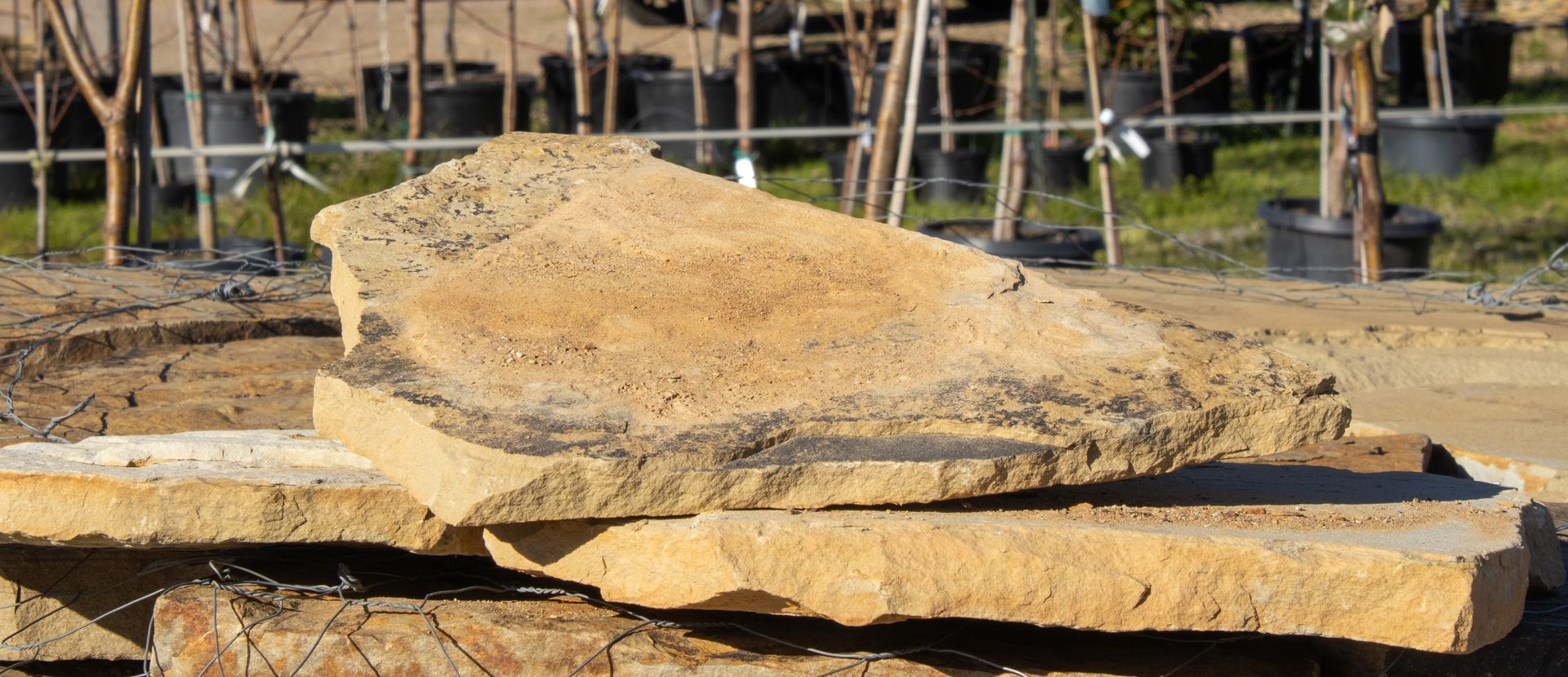A pile of rocks sitting on top of each other in a field.