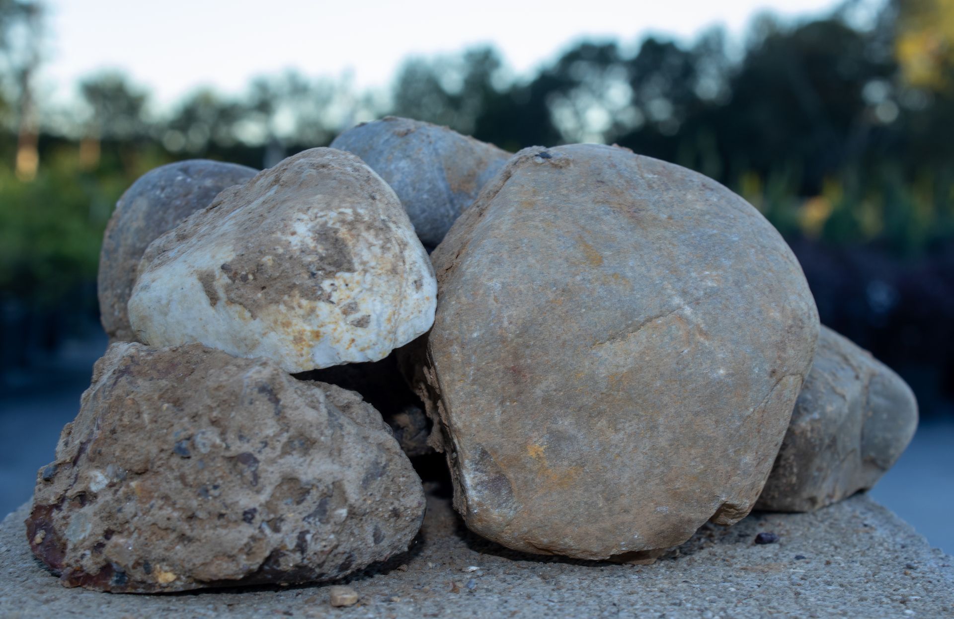 A pile of rocks sitting on top of a sandy surface.