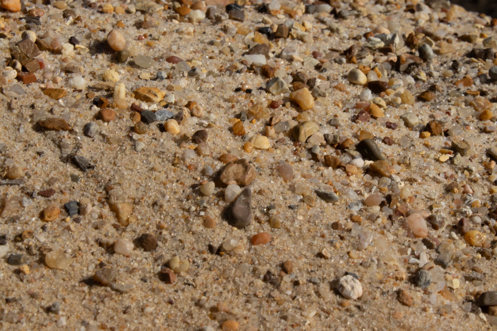 A pile of sand and rocks on a beach.