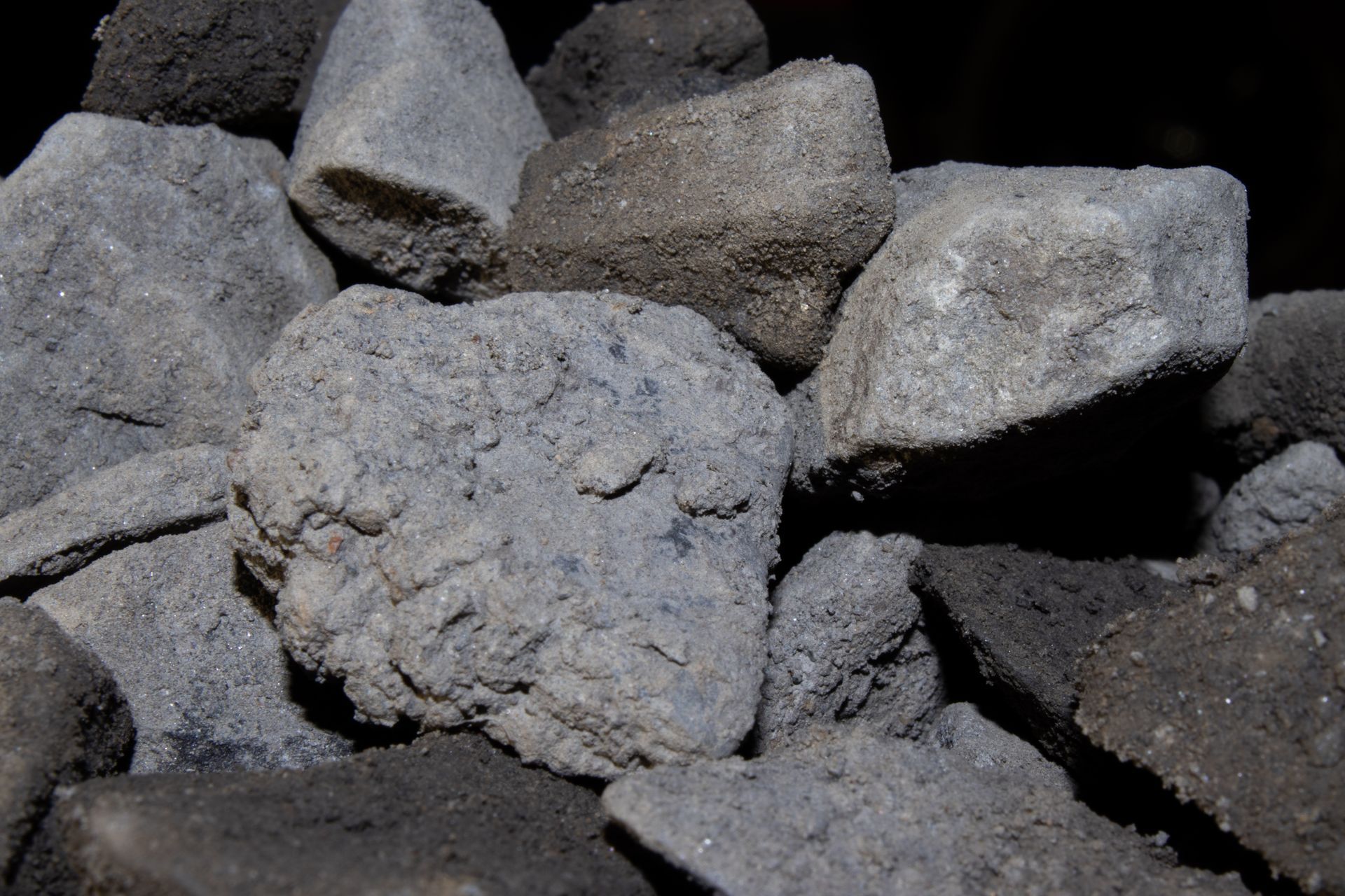 A pile of rocks sitting on top of each other on a black background.