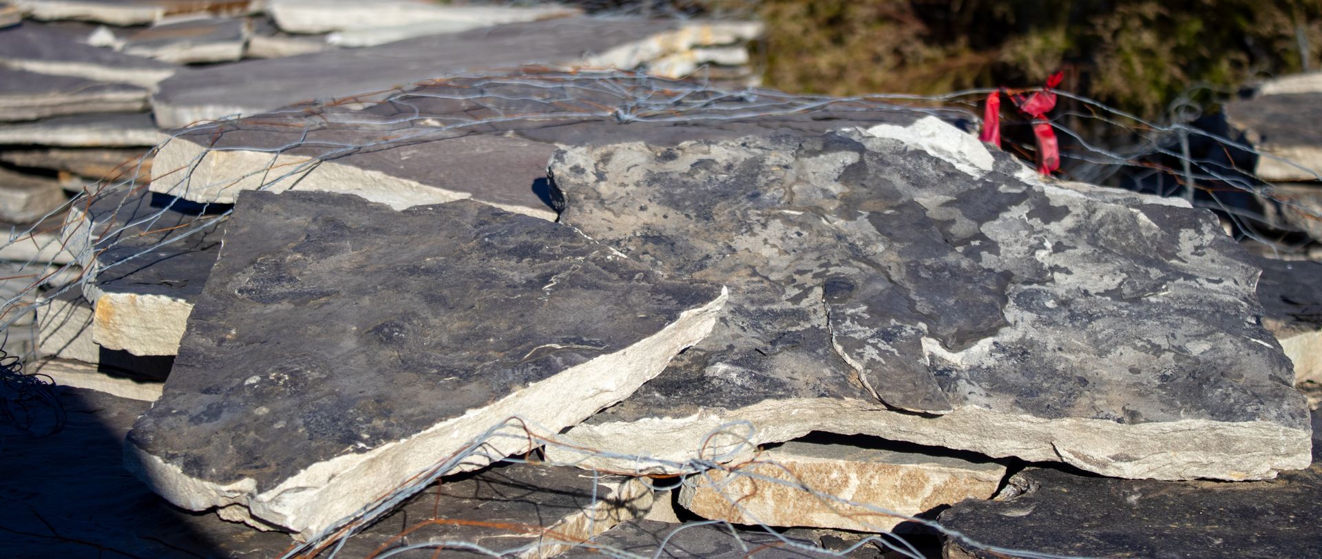 A pile of rocks sitting on top of each other on the ground.