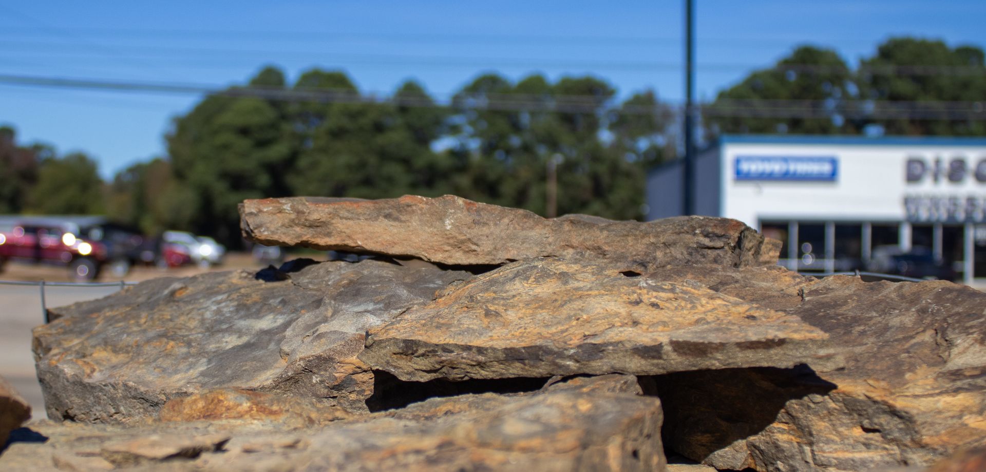 A pile of rocks is sitting in front of a building.